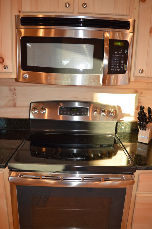 electric stove, oven and microwave at log cabin