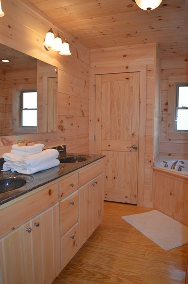 bathroom with jacuzzi tub at vacation rental log cabin