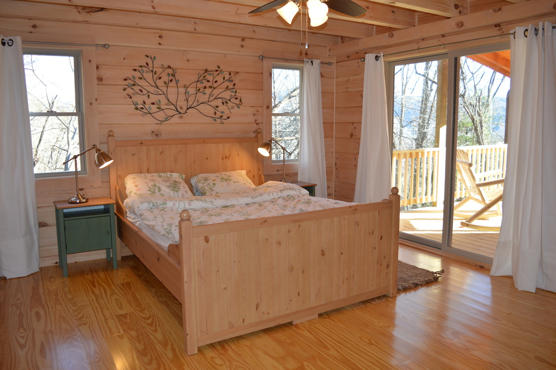 master bedrooom, beamed ceiling at vacation rental log cabin