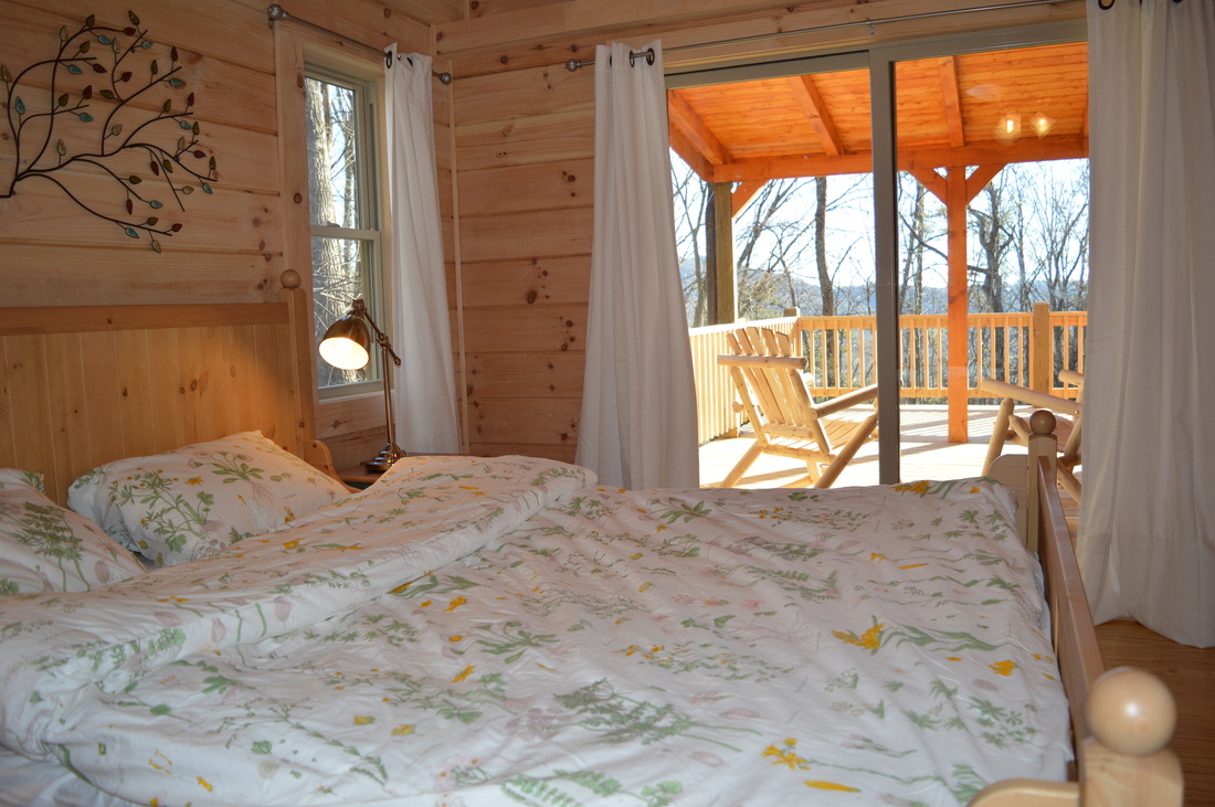 sliding glass doors to covered porch at vacation rental log cabin