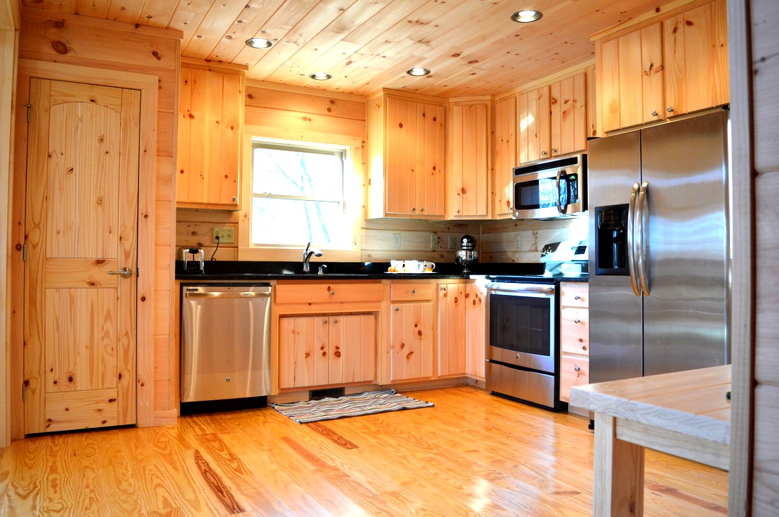 stainless steel appliances in log cabin kitchen